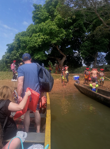 Tourists arriving at the Embera village on traditional dugout canoes along the Chagres River.